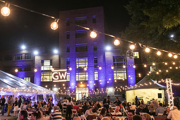 photo - alumni gather at an outdoor party during Colonials Weekend at GW