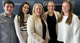 GWSB Professor Bonnie Pierce (center) pictured with some of her Fall 2023 capstone students
