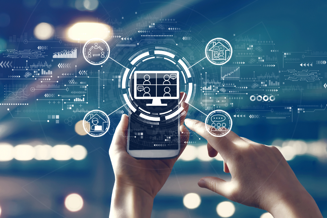 A person's hands appear, holding a smartphone. Icons beam from the smartphone screen, illustrating human and technology interaction.