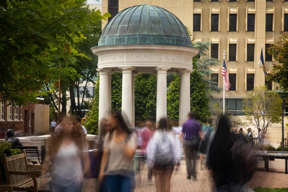 Students pass by the tempietto in Kogan Plaza