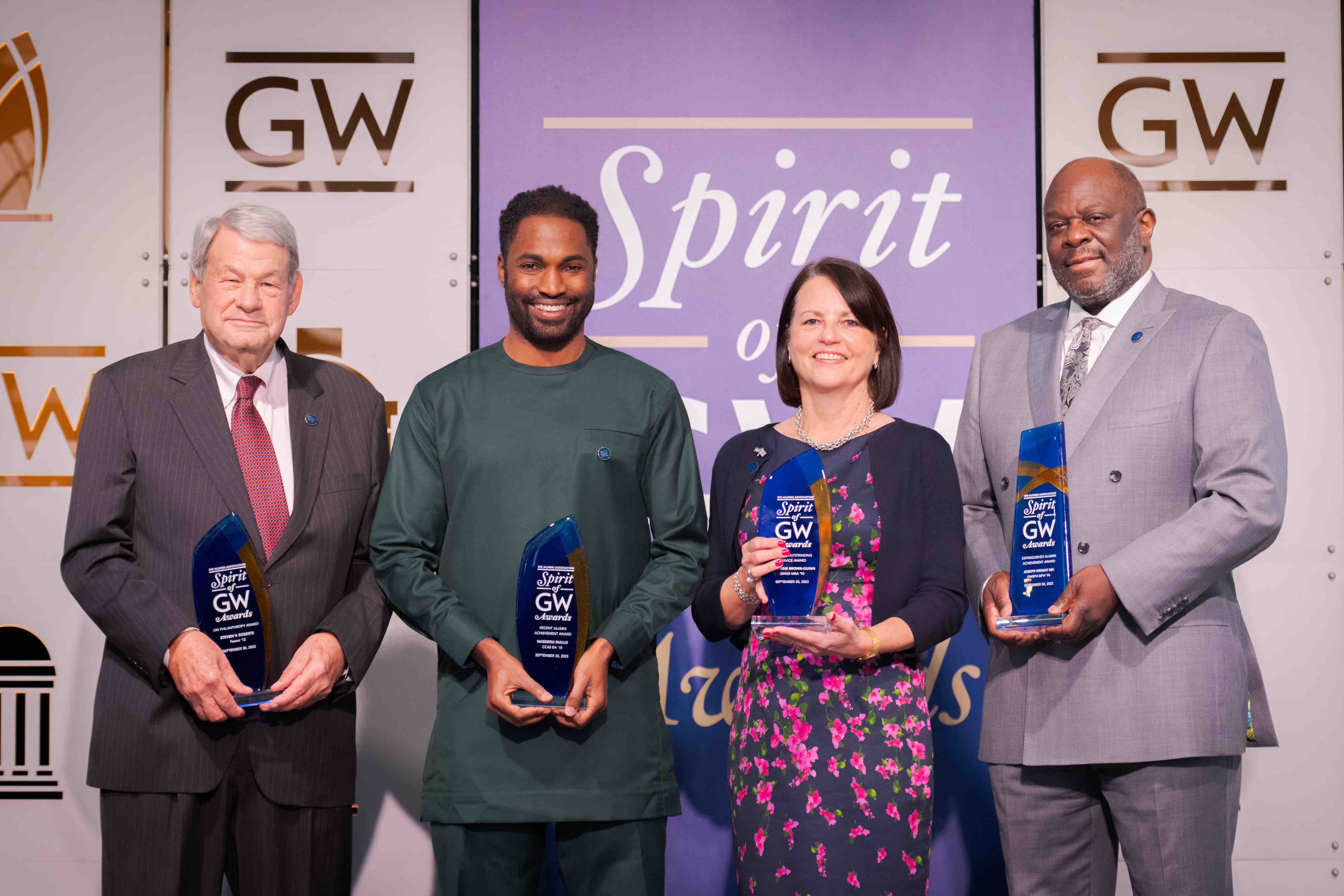 Steven V. Roberts, Nassirou Diallo, Christine Brown-Quinn and Joseph Wright posing with their Spirit of GW awards