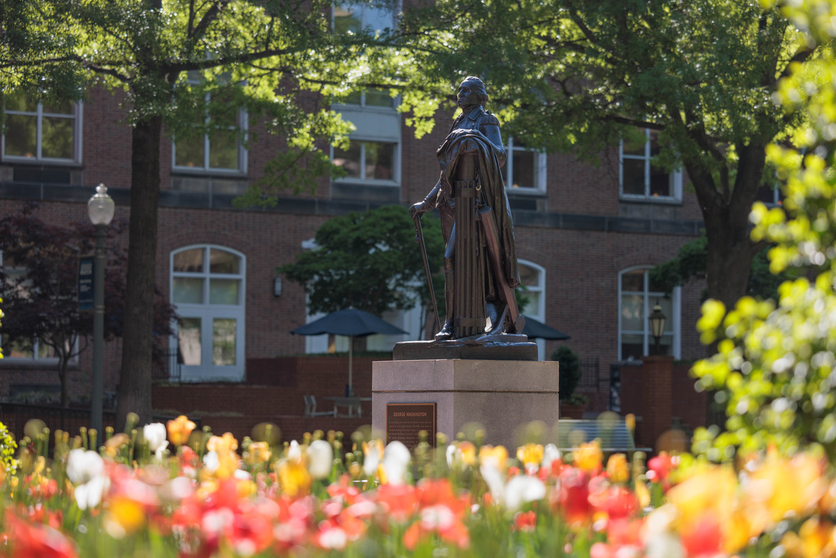 George Washington statue in University Yard surrounded by blooming tulips