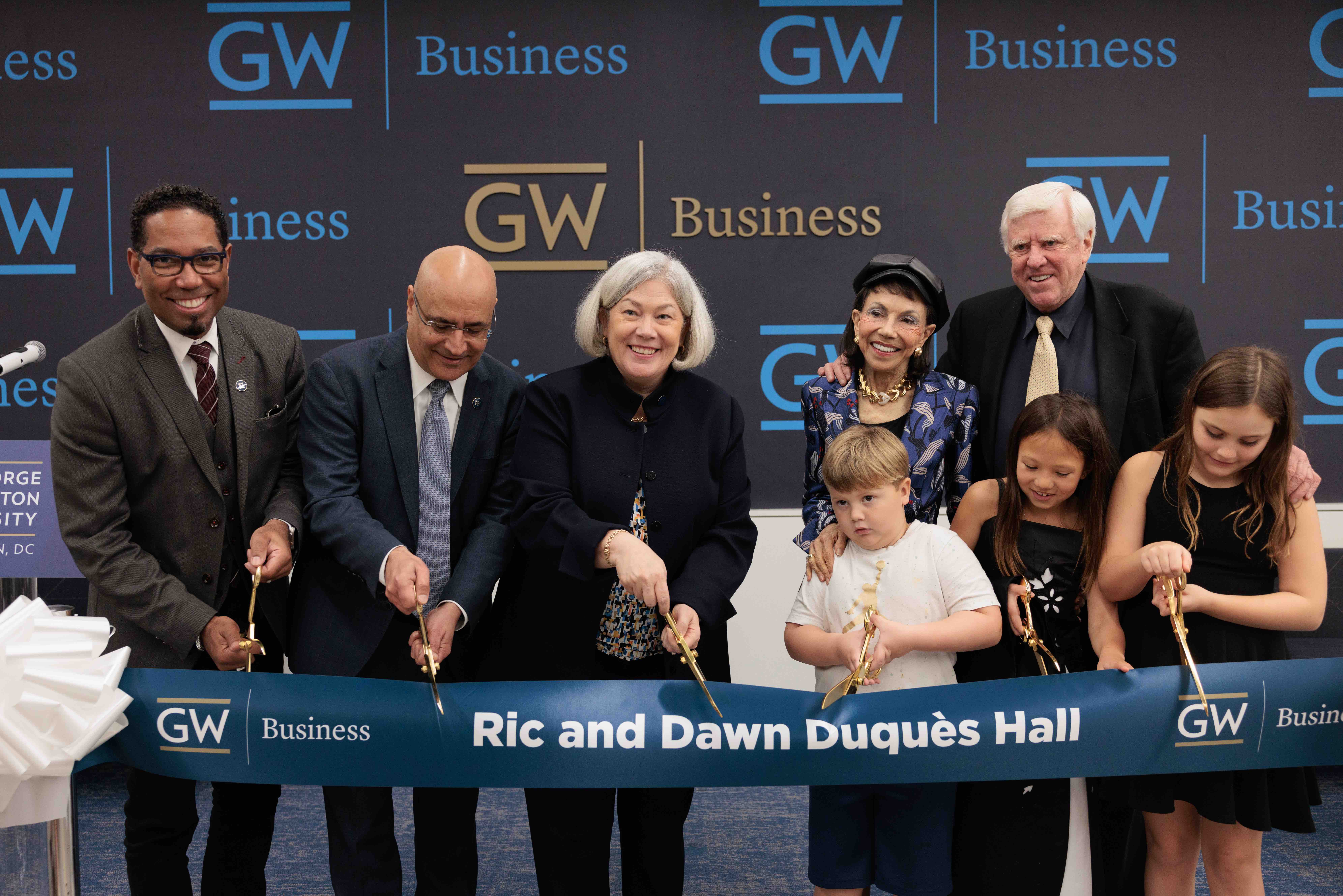 Provost Christopher Bracey, GWSB Dean Anuj Mehrotra, President Ellen M. Granberg, Dawn Duquès, Ric Duquès and the Duquès grandchildren.