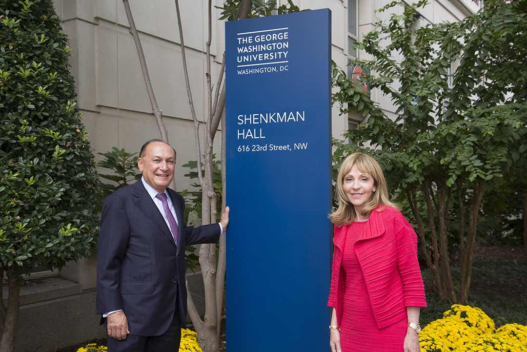 Mark and Rosalind Shenkman in front of the Shenkman Hall sign