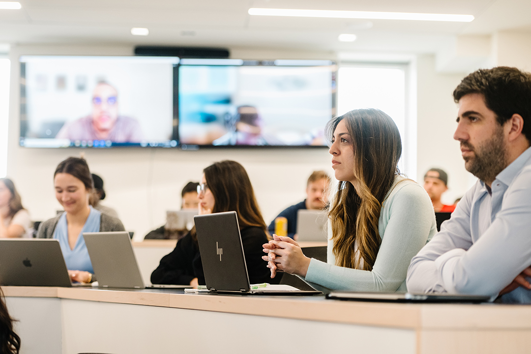 GWSB students listen as a professor lectures during a class on AI