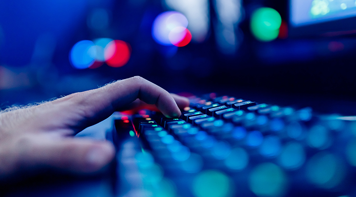 close-up wide-angle image of fingers typing on a keyboard