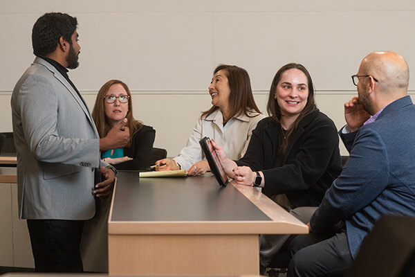 GWSB faculty and students talk in classroom