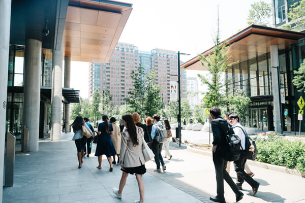 Participants of DC Study Away walk away from the camera in a city setting with modern buildings