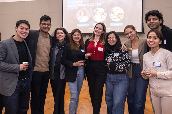 group of GW Business students pose for group photo at event