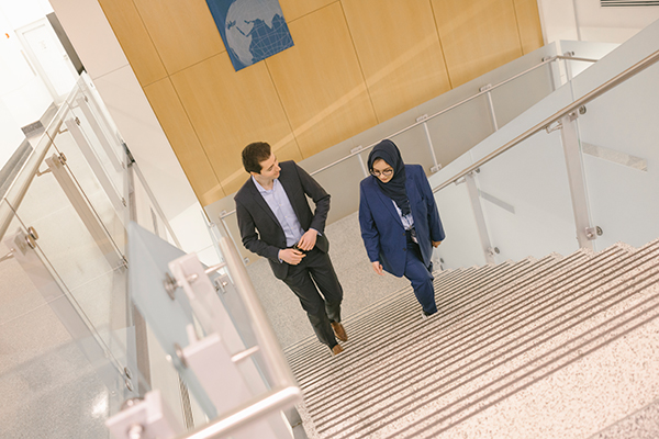 two students walk up stairs