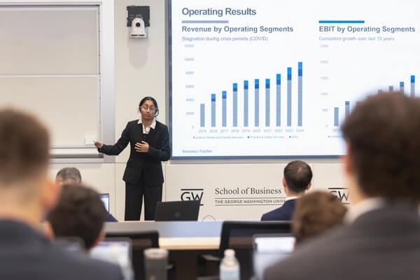 student presents data on screen in front of class