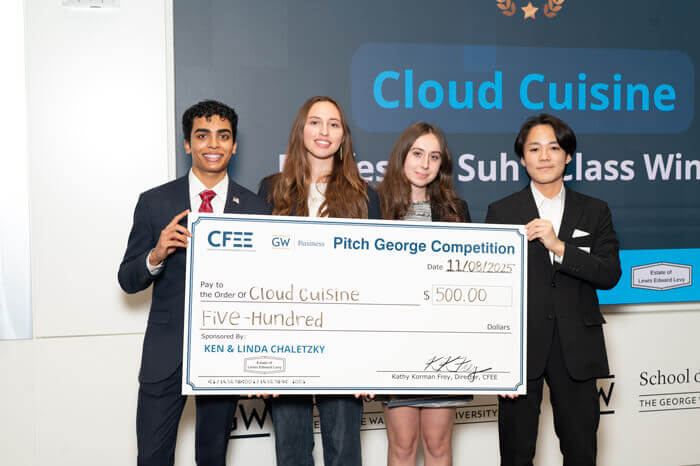 4 members of the Cloud Cuisine group pose with a large check for $500