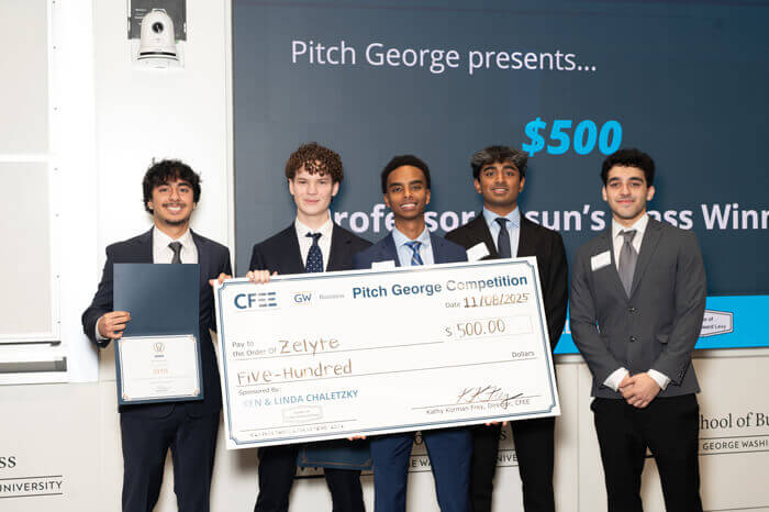 Five members of the Zelyte group pose with a large check for $500