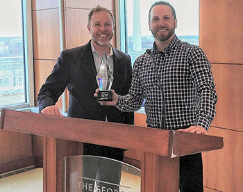 photo - Dan Simons (right) receives the Don Hawkins Tourism Innovation Award from Prof. Stuart Levy