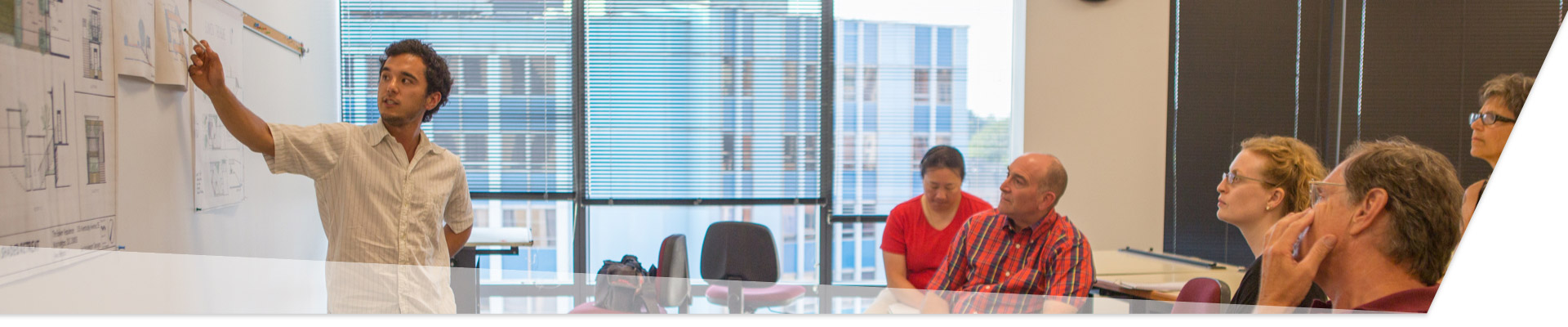 photo - GWSB research landing page hero image - GW professors discuss ideas in a classroom