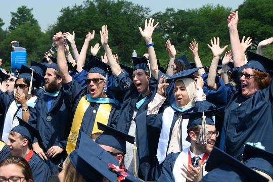 Graduates celebrate in their regalia on the National Mall