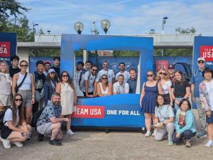GW graduate students pose in front of Team USA photo opportunity