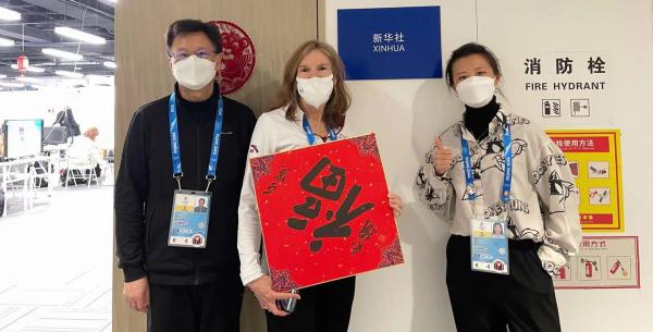 (Pictured from left to right) Zhou Jie, GWSB Professor Lisa Deply Neirotti, and Yixing Dong stand outside the Xinhua News Agency room in the main Olympics media center in Beijing, China.