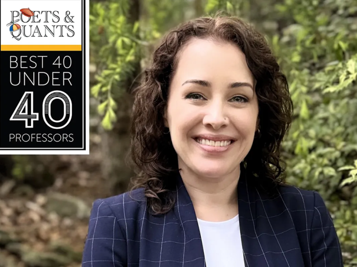 Poets & Quants Best 40 Under 40 Professors. Image shows GW Professor Vontrese Pamphile. Trees are visible in the photo background.