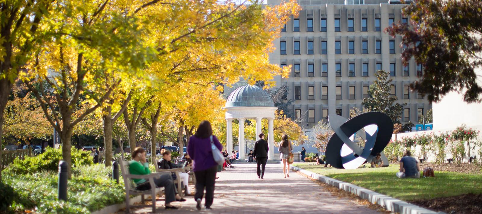 students walk through Kogan Plaza on the GW campus in Washington, D.C. during early fall