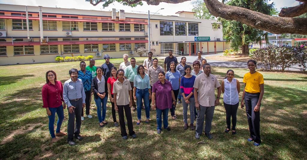 Researchers gather for a photo on the front lawn of the Cocoa Research Center at the University of the West Indies in Trinidad & Tobago