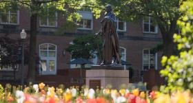 George Washington statue in University Yard surrounded by blooming tulips