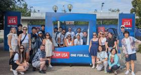 GW graduate students pose in front of Team USA photo opportunity