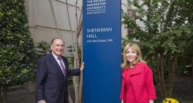 Mark and Rosalind Shenkman in front of the Shenkman Hall sign